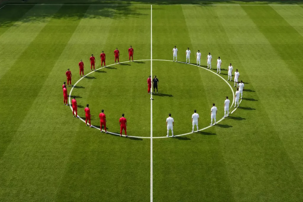 Voetbalveld vanuit hoog standpunt met twee teams klaar voor de aftrap